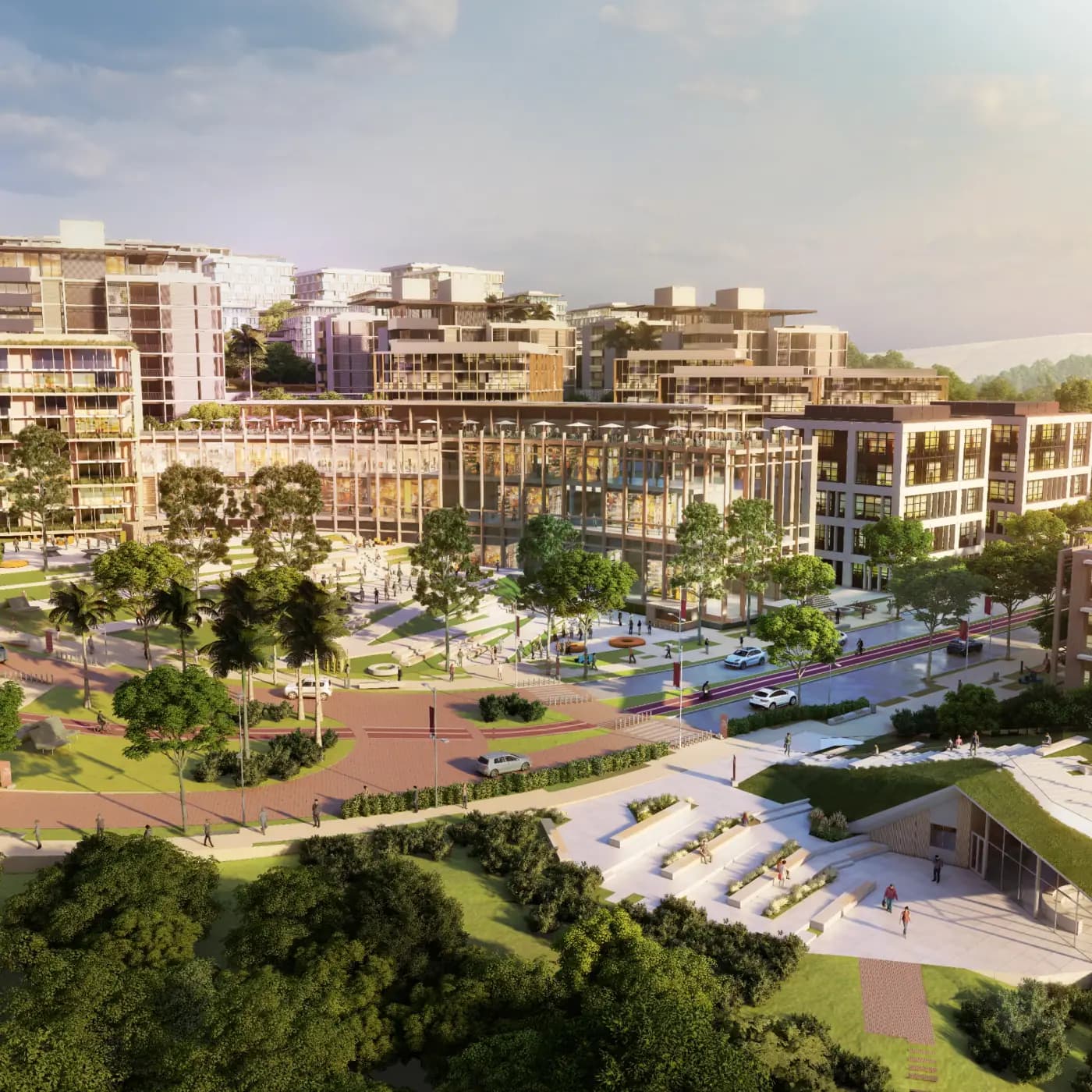 Centralidade Boulevard: praça arborizada com pessoas circulando diante de um edifício comercial de galeria envidraçada, cercado por prédios residenciais.